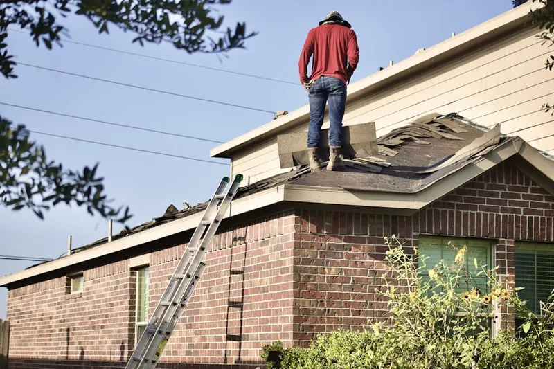 Professional roofer working on a residential roof in Lemoyne